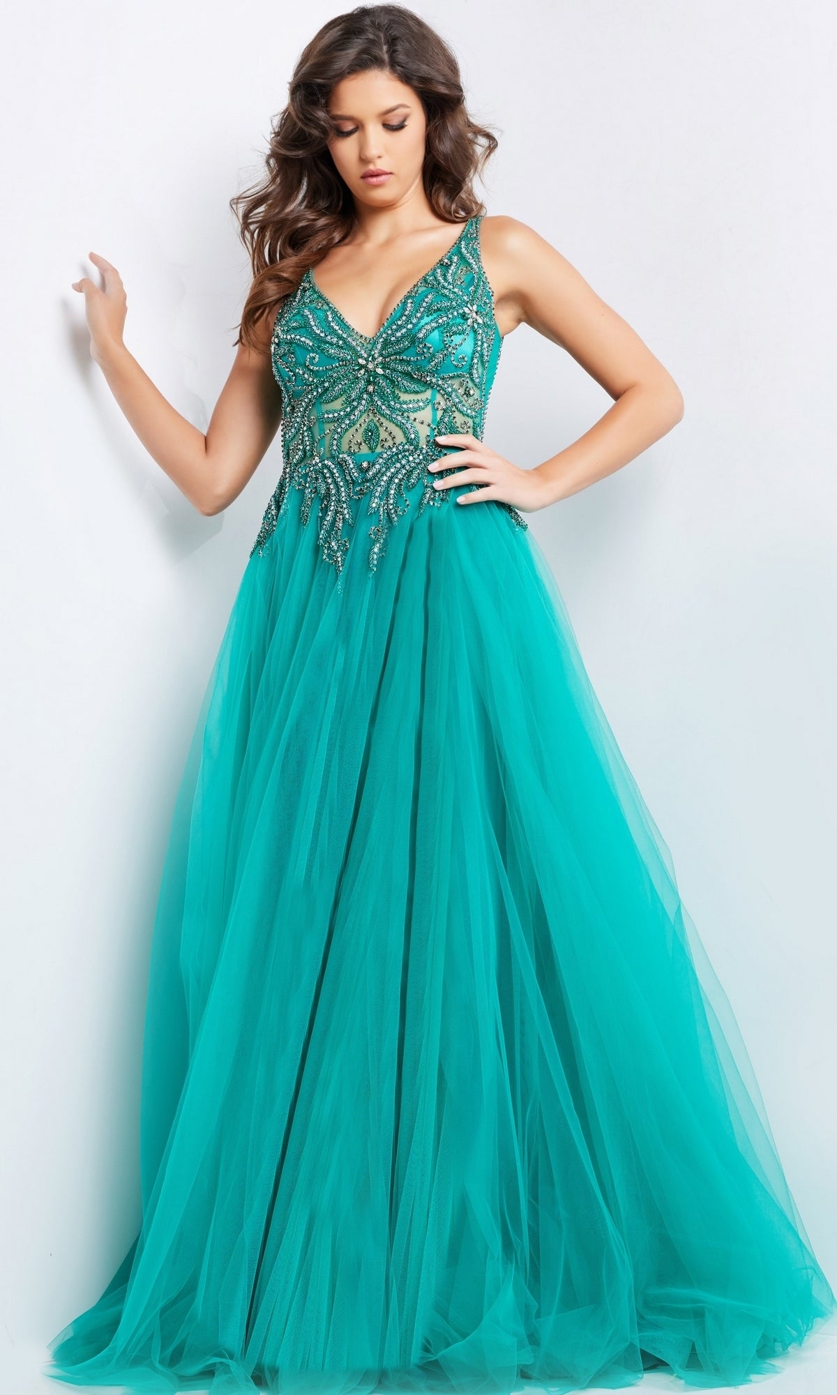A woman models the Jovani Beaded-Bodice Long Prom Ball Gown 23962, a sleeveless aqua dress with a beaded bodice and full tulle skirt, against a plain white background.
